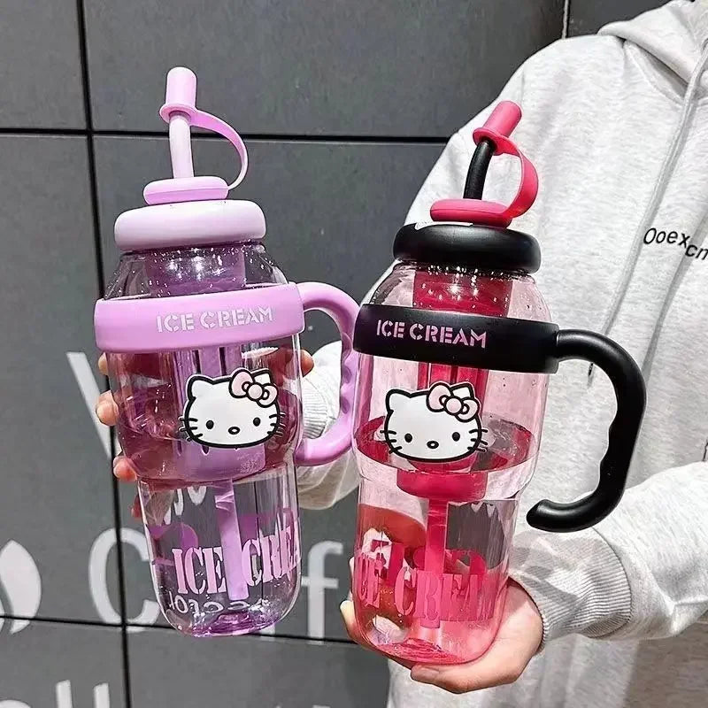 Two colorful water bottles with Hello Kitty design held by a person against a gray tiled wall.