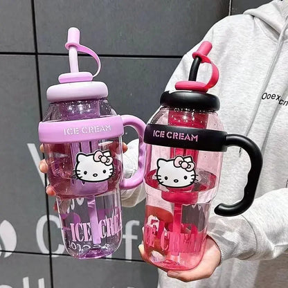 Two colorful water bottles with Hello Kitty design held by a person against a gray tiled wall.