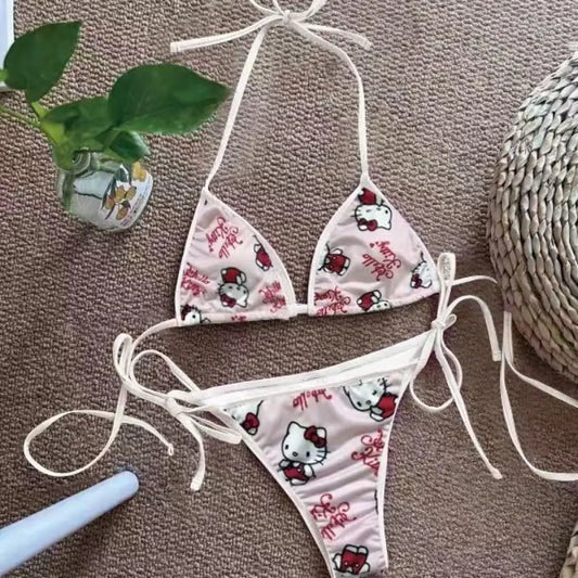 Hello Kitty bikini set on a textured surface with decorative elements.