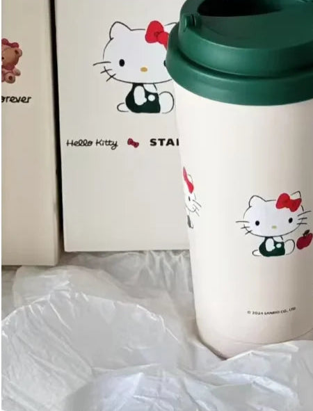Hello Kitty tumbler with green lid on a white surface