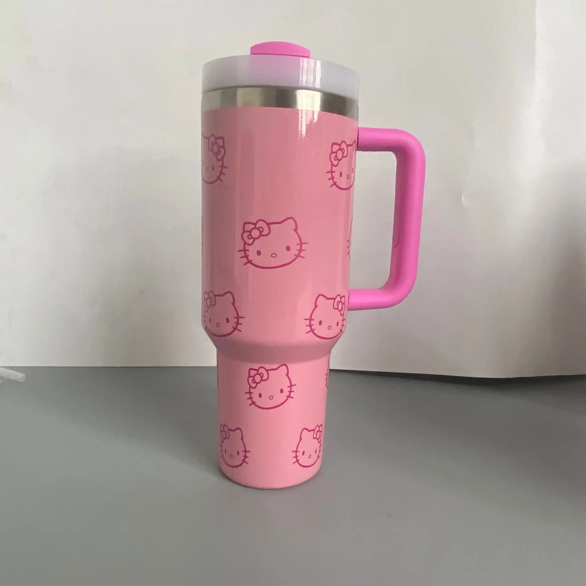 Pink tumbler with Hello Kitty design on a white background