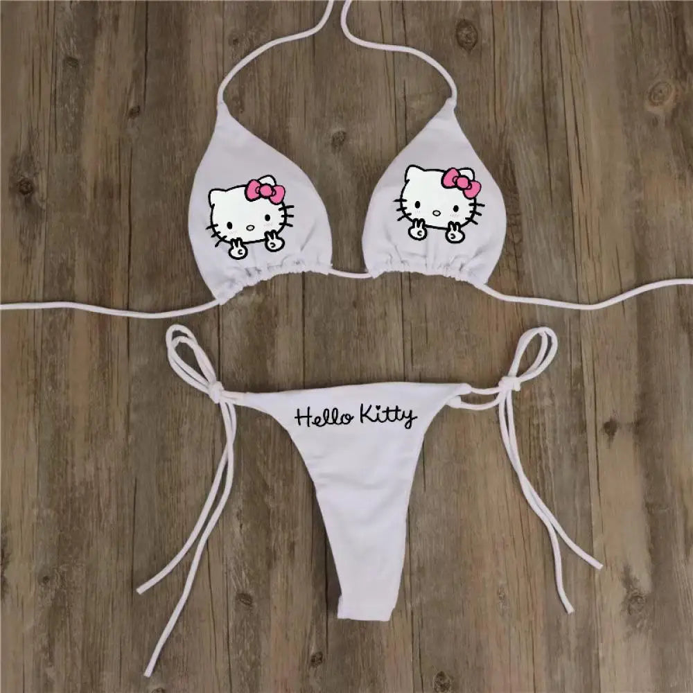 White bikini set with Hello Kitty design on a wooden background