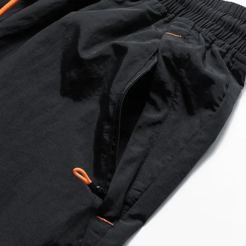 Black jacket with orange zippers on a white background