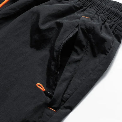 Black jacket with orange zippers on a white background