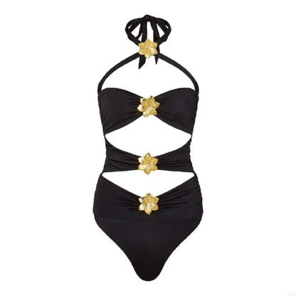Black swimsuit with gold floral accents on a white background
