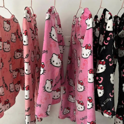 Hello Kitty pajama sets hanging on a rack with pink and black patterns.