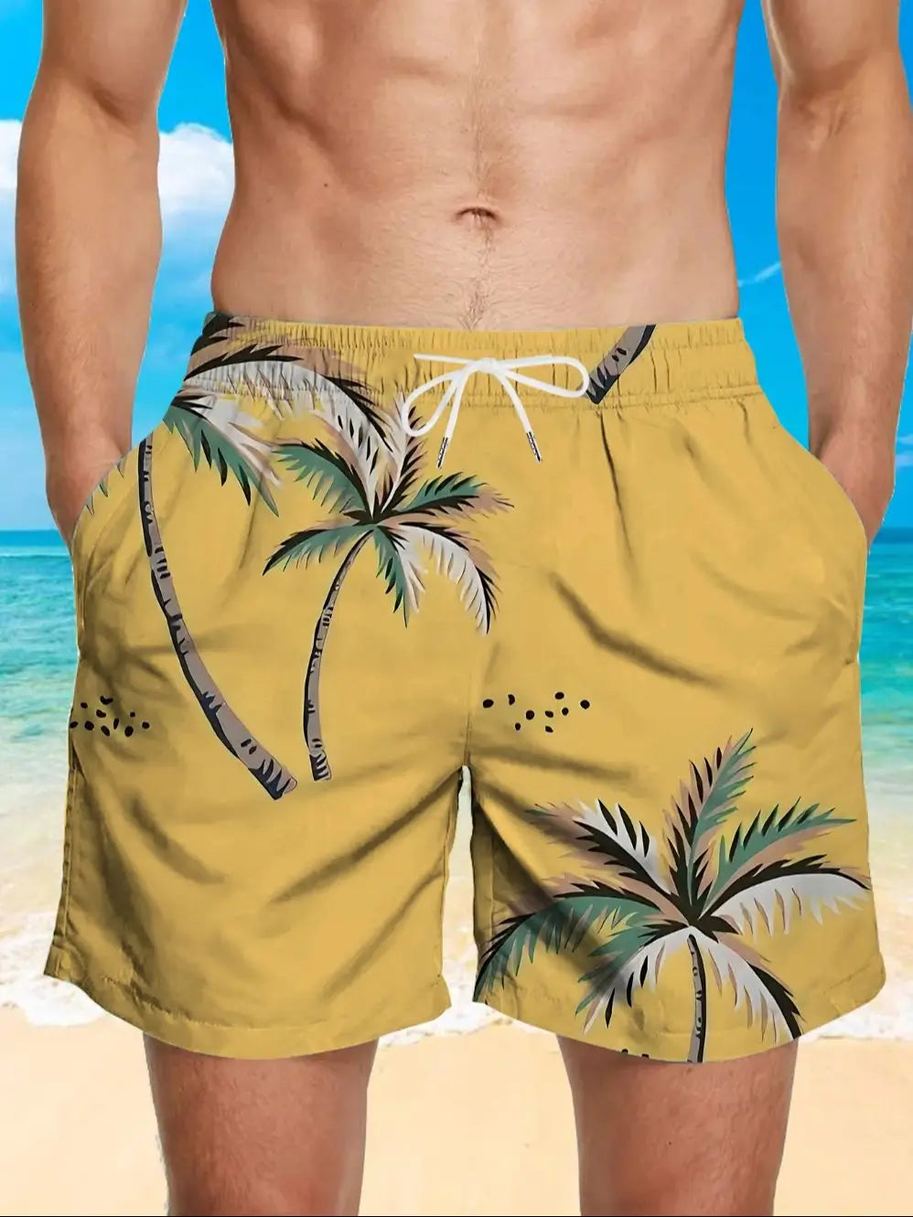 Yellow swim shorts with palm tree design on a beach background