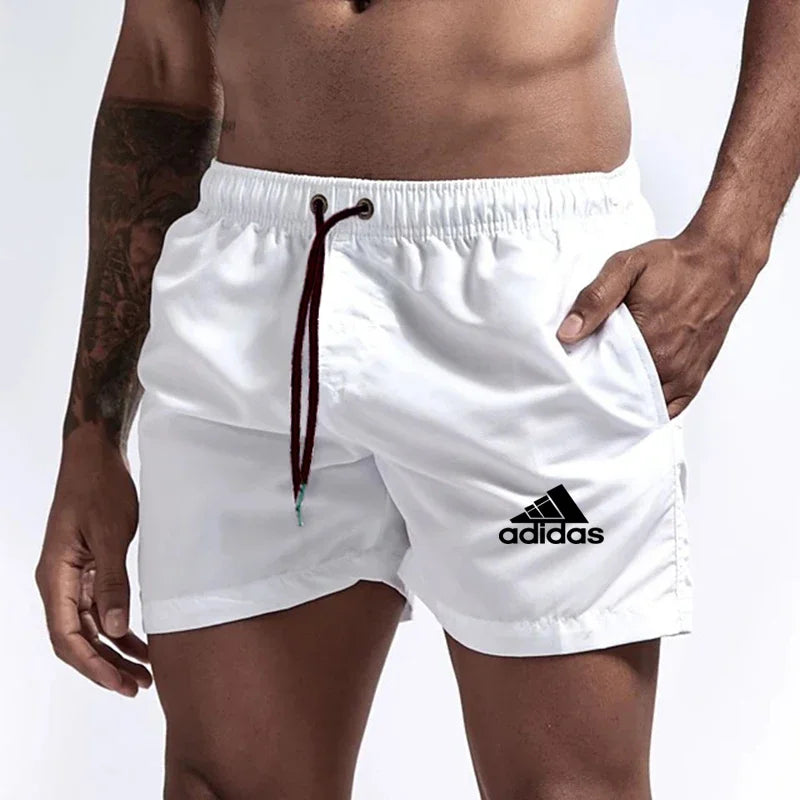 White Adidas shorts worn by a person on a white background