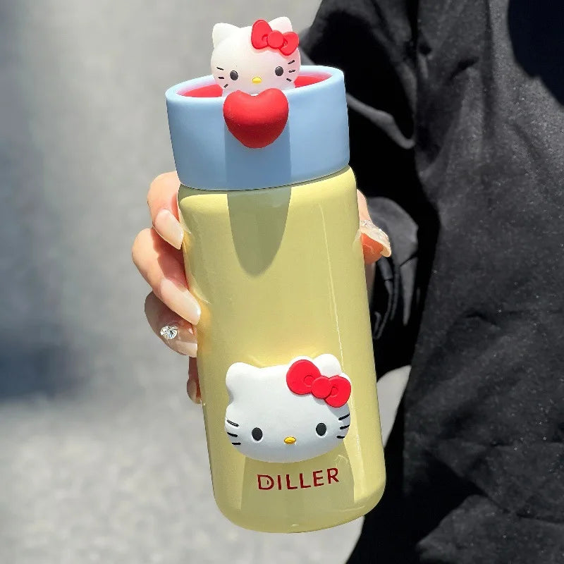 Yellow water bottle with Hello Kitty design held by a person