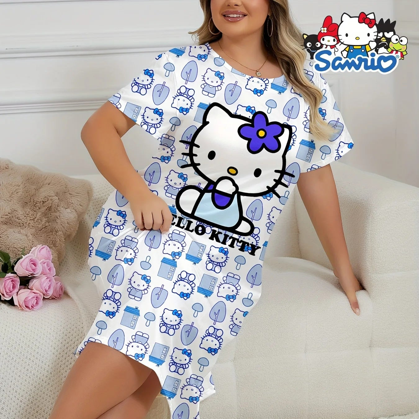 Child wearing a Hello Kitty nightshirt sitting on a bed with a white background