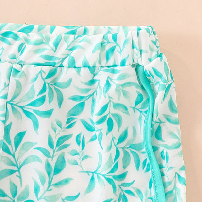 Close-up of a skirt with a green leaf pattern on a beige background