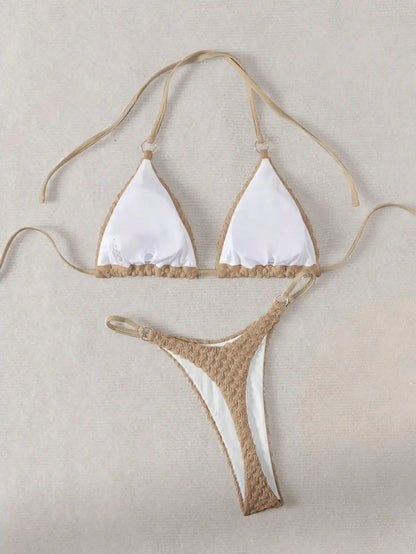 Beige and white bikini set on a beige background