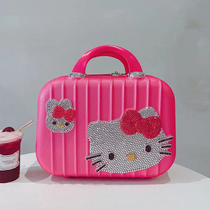 Pink Hello Kitty suitcase with a cup of ice cream on a white surface
