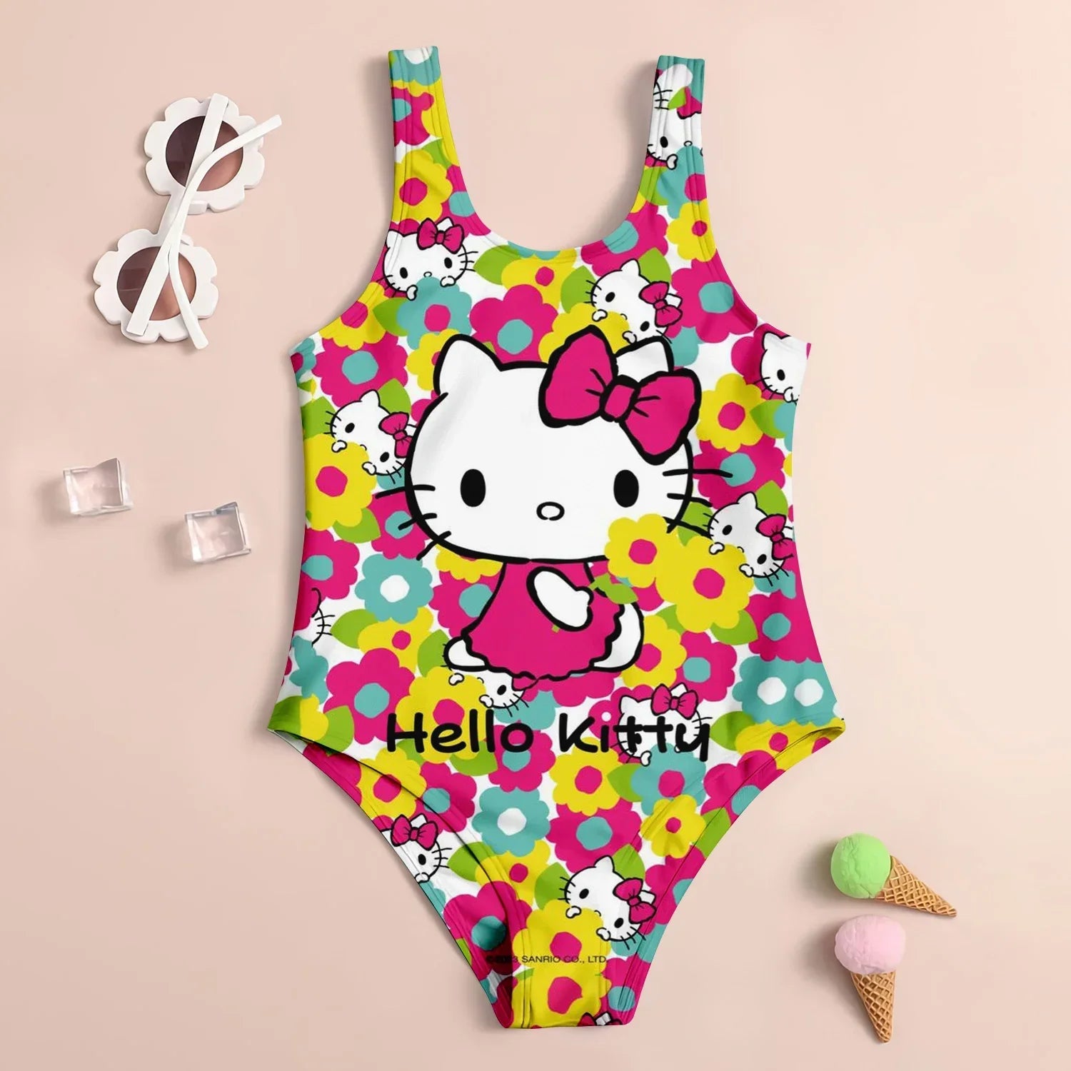 Colorful Hello Kitty swimsuit on a beige background with sunglasses and ice cream cones.
