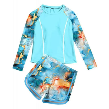 Children's two-piece swimsuit with long-sleeve top and shorts in blue with gold and orange abstract design on a white background.