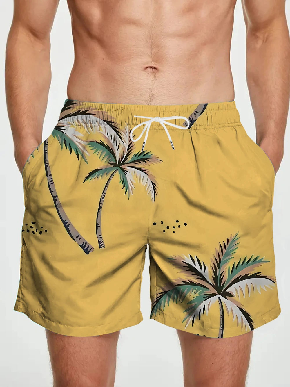 Yellow swim shorts with palm tree design on a plain background