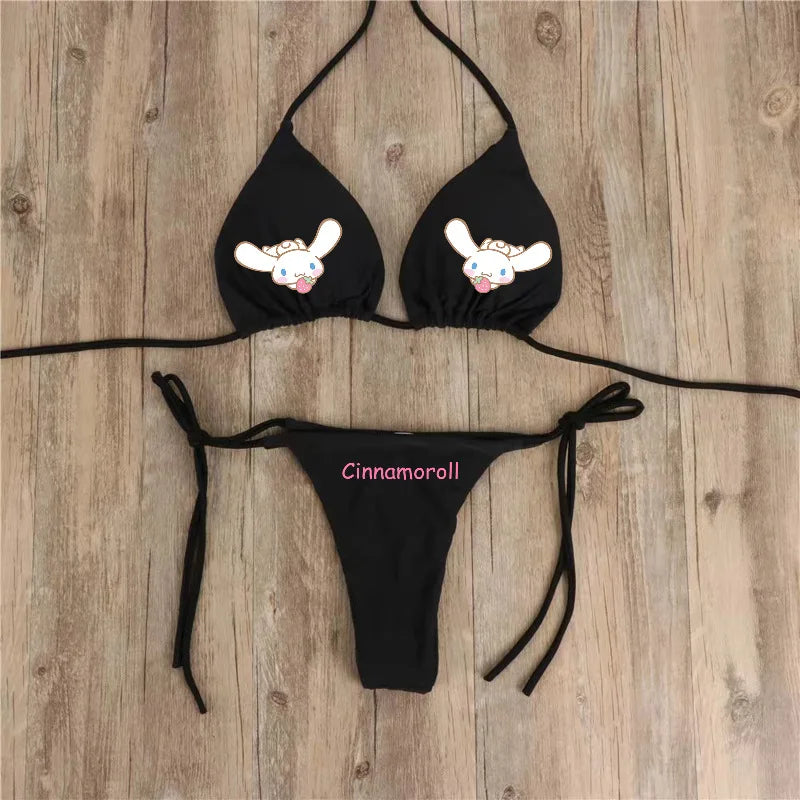 Black bikini set with cartoon character design on a wooden surface