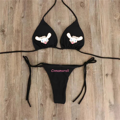 Black bikini set with cartoon character design on a wooden surface
