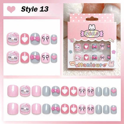 Set of cartoon-themed false nails with packaging on a pink background