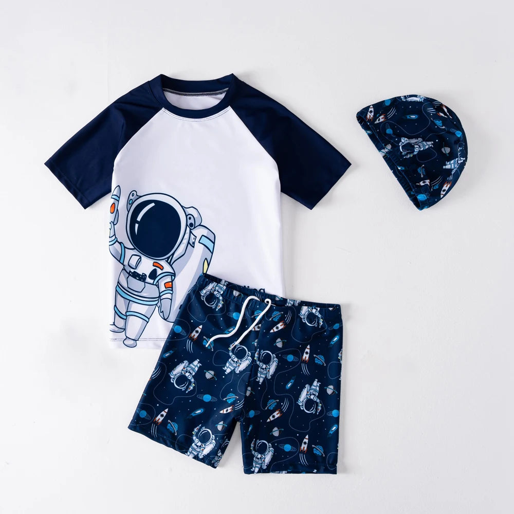 Children's outfit with astronaut-themed shirt, shorts, and hat on a white background