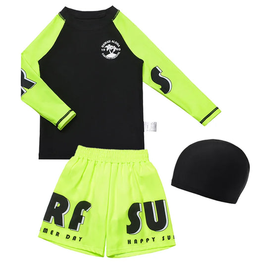 Children's swim set with black and green rash guard, shorts, and swim cap on a white background