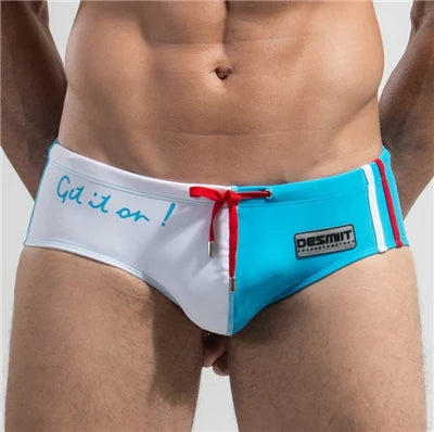 Blue and white swim briefs with red drawstring on a plain background