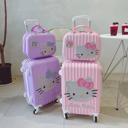 Set of pink and purple Hello Kitty suitcases on a light-colored floor.