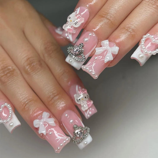Nails with pink and white decorations on a neutral background