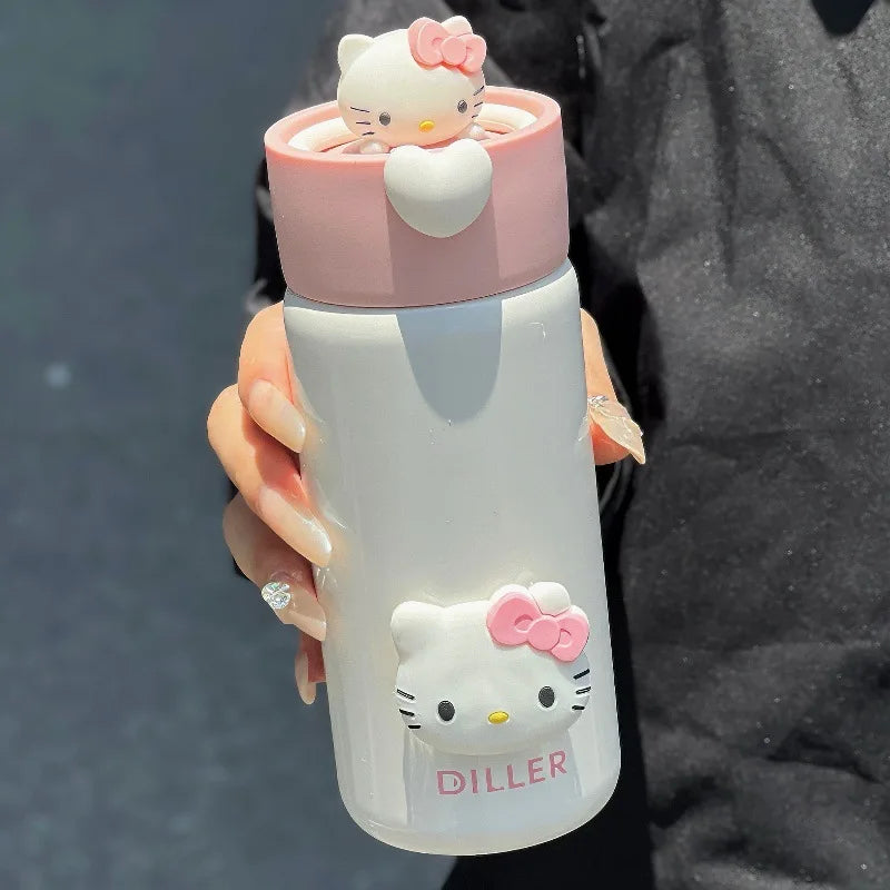 Hello Kitty-themed water bottle held by a person with a dark background