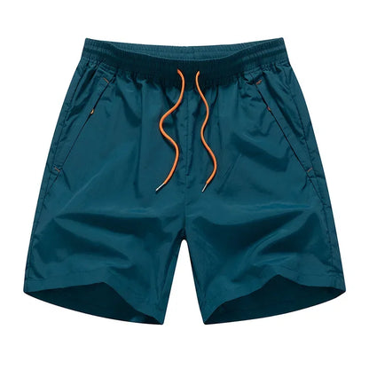 Teal shorts with orange drawstring on a white background