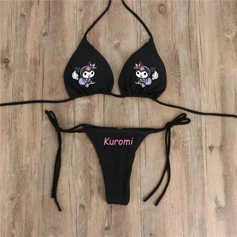 Black bikini set with 'Kuromi' branding on a wooden surface