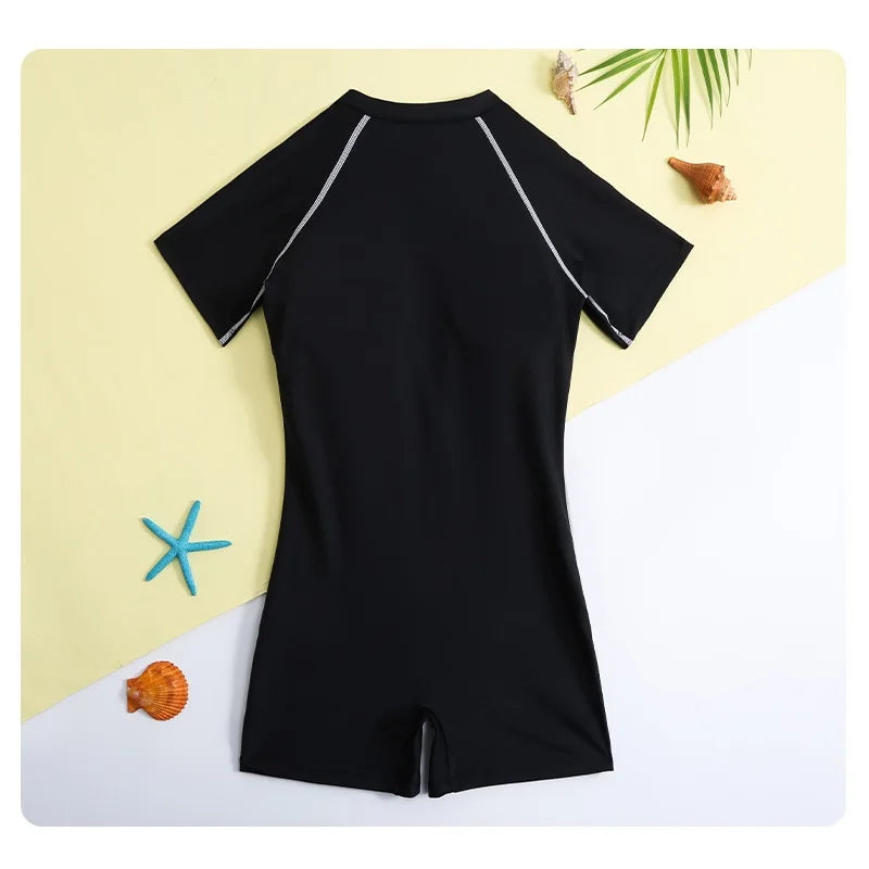 Black swimsuit with short sleeves on a yellow and white background with decorative elements.
