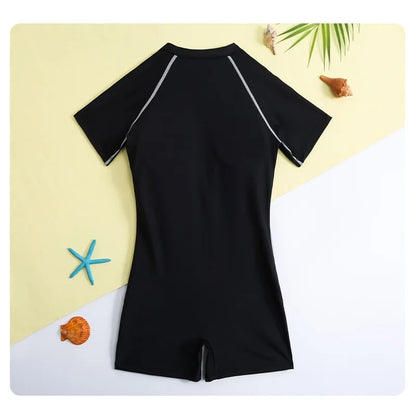Black swimsuit with short sleeves on a yellow and white background with decorative elements.