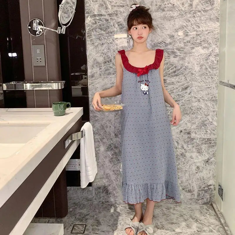 Woman in a blue dress with red trim standing in a bathroom.