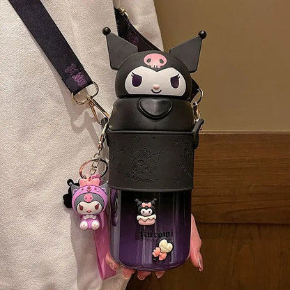 Black and purple water bottle with cartoon character design held by a person.