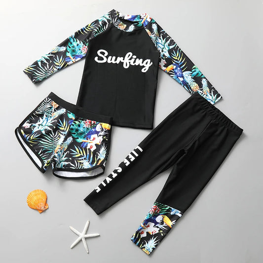 Surfing-themed swimwear set with floral sleeves and pants on a gray background