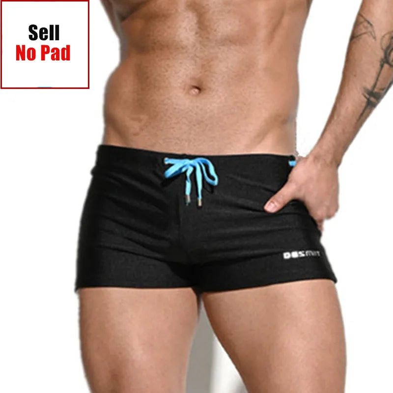 Black swim shorts with blue drawstring on a white background