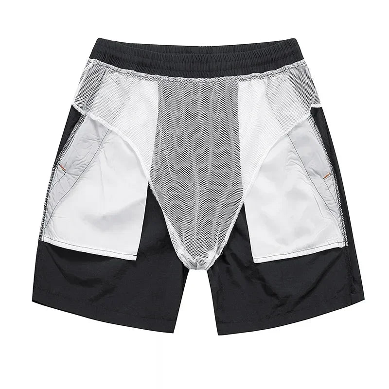 Black and white shorts with mesh panels on a white background