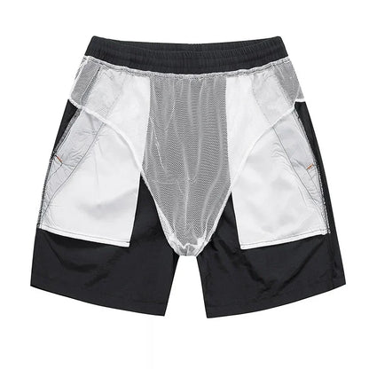Black and white shorts with mesh panels on a white background