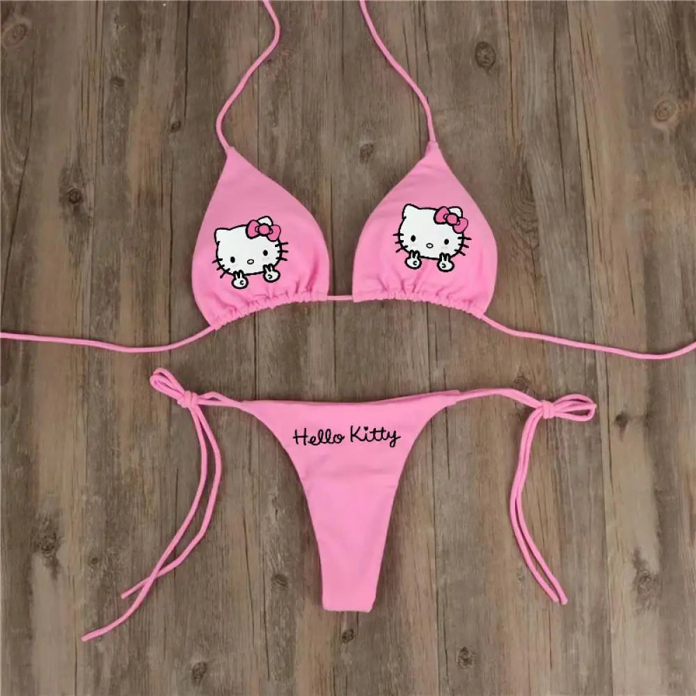 Pink 'Hello Kitty' bikini set on a wooden background