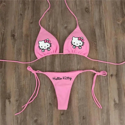 Pink 'Hello Kitty' bikini set on a wooden background