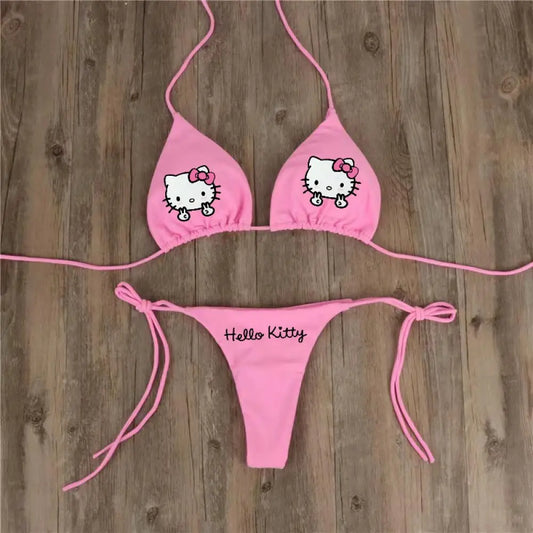 Pink 'Hello Kitty' bikini set on a wooden background