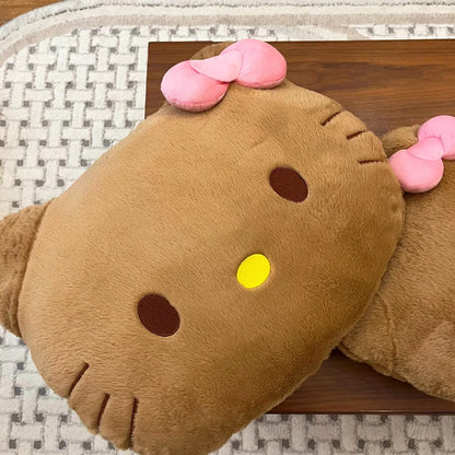 Plush toy resembling a cat with a pink bow on a wooden surface