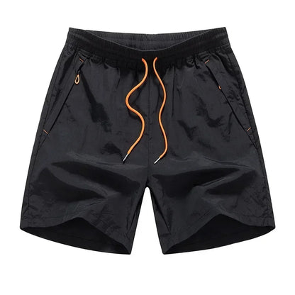 Black shorts with orange drawstring on a white background