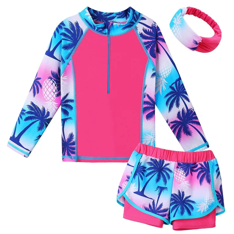 Children's swimsuit set with pink top and shorts featuring palm tree pattern, accompanied by a matching headband.