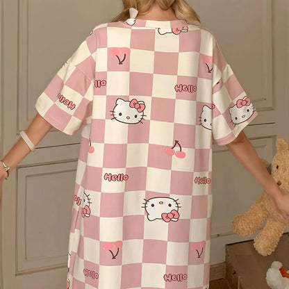 Person wearing a pink and white checkered dress with Hello Kitty designs in a room.