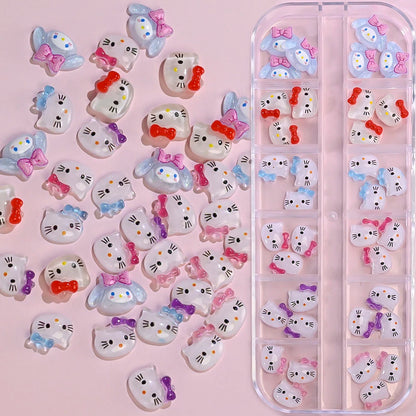 Cartoon cat-shaped nail art stickers with colorful bows on a pink background