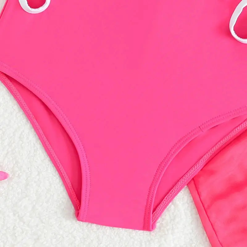 Close-up of a pink swimsuit on a white background