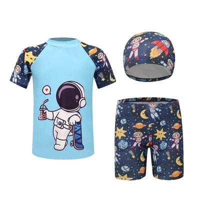 Children's swim set with blue shirt, navy shorts, and cap featuring space-themed designs on a white background.