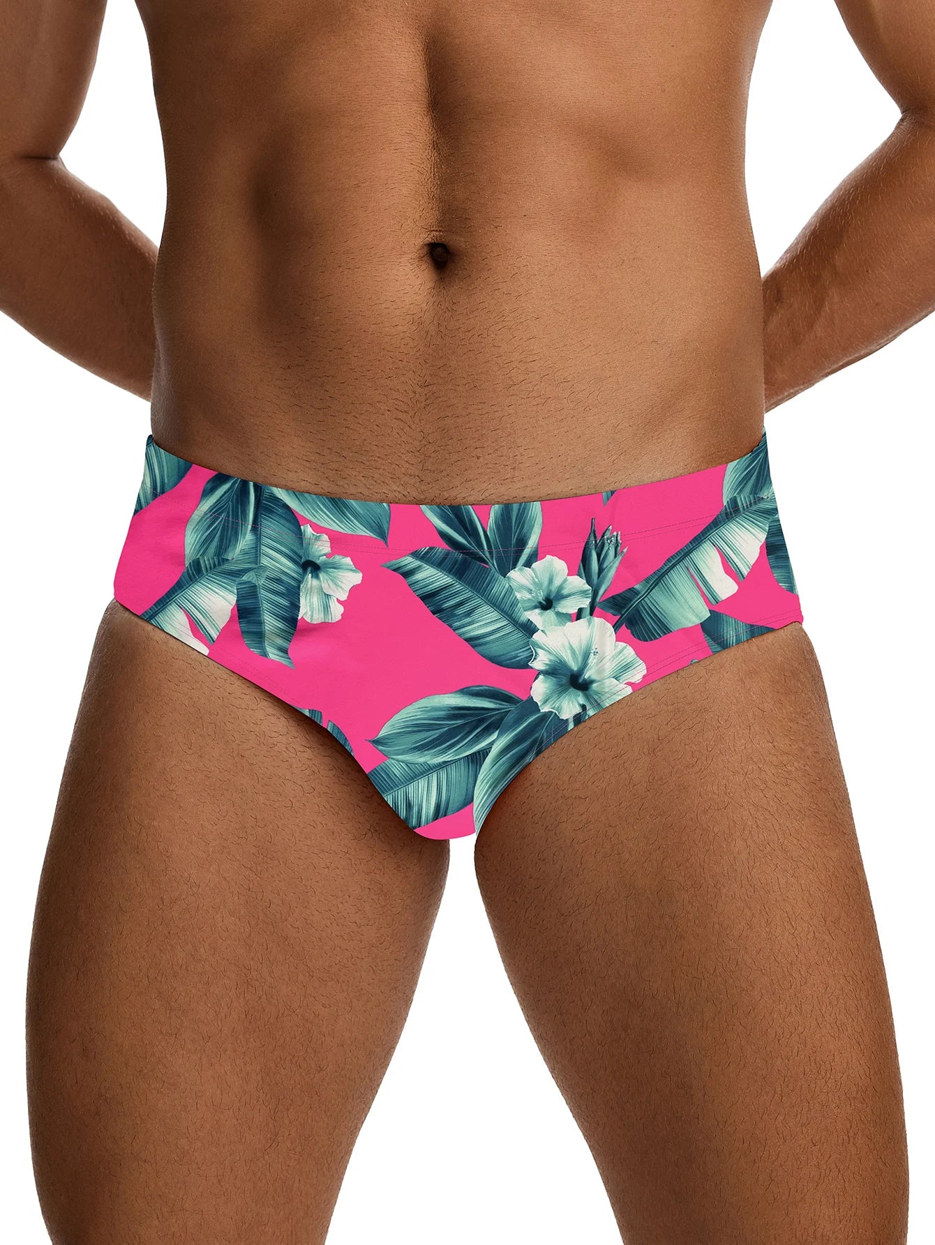 Tropical leaf patterned swim briefs on a white background